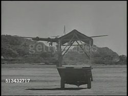 1944: B-29 SUPERFORTRESS BOMBER AIRPLANE:  WS TRACKING B-29 Superfortress bomber aircraft descending, approaching frame, landing on airstrip at military airbase. World War II, WWII, United States Air Force, USAF Instructional Video