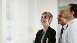 Business people having meeting at whiteboard Stock Footage