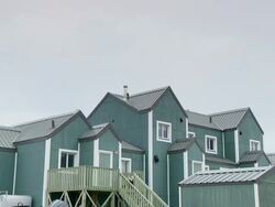 WS TD Shot of wooden home with speed boats / Arviat, Nunavut, Canada Stock Footage