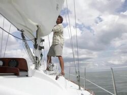 man releasing the sail on yacht /tampa,florida,USA Stock Footage