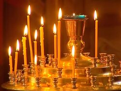 Burning wax candles during church ritual in a temple. Stock Footage