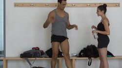 Young dancer talking while showing ballet steps to friend in studio Stock Footage