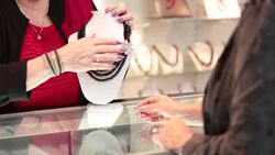 Small business owner Jeweller showing bead necklace Stock Footage