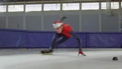 MS SLO MO Short track speed skater making turn during race on track in arena Stock Footage