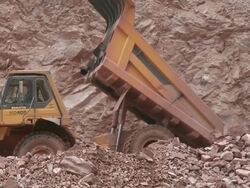MS Truck pitching stone at quarry / Taben-Rodt, Rhineland-Palatinate, Germany Stock Footage