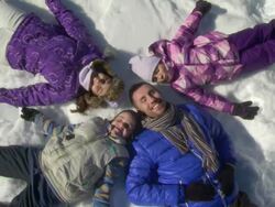 HD CRANE: Family Relaxing Under The Winter Sun Stock Footage