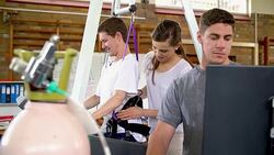 Physical therapist helping man with spinal injury in hoist Stock Footage