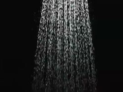 CU SLO MO Shot of Wide spray of water moving through frame against black background / United Kingdom Stock Footage