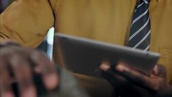 Modern clothing store employee counts stock and enters info on tablet Stock Footage