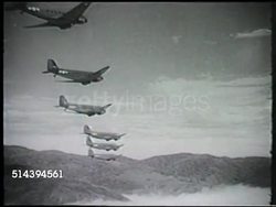 1942: BATTLE OF BUNA: VS Squadron of Douglas C-47 Skytrain planes flying over Buna, Owen Stanley Range, soldier riding in plane looking out window, flying over jungles. WWII, World War II, Pacific Front, New Guinea Campaign Instructional Video