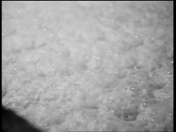 B/W 1932 close up foaming + bubbling liquid / whiskey production / Louisville, KY Stock Footage