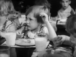 B/W 1934 little girl eating in nursery school / WPA project / newsreel Stock Footage