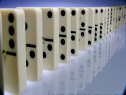 High Speed Dominoes - MCU side angled view, long row of dominoes fall over away from camera Stock Footage