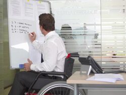 HD DOLLY: Handicapped Businessman Working In Office Stock Footage