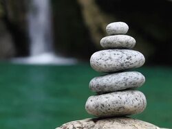 Balanced stones on waterfall background Stock Footage