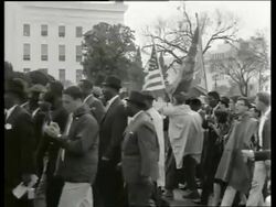 B/W 1960's people in civil rights march past Capitol bldg / Montgomery, Alabama / SOUND Stock Footage