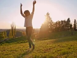 Girl makes cartwheels in grass Stock Footage
