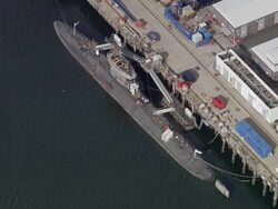 Aerial overhead view of Royal Navy submarine docked at Faslane Naval Base / Scotland Stock Footage