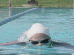 CU SLO MO Shot of Woman, baby boomer, in swim cap swimming breast stroke / Davis, California, United States  Stock Footage