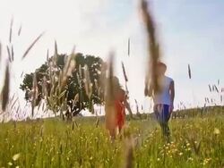 SLO MO Mother and daughter running in the meadow Stock Footage
