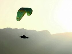 HD: Backlit Silhouette Of A Paraglider Stock Footage