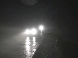 Cars driving by camera at night in fierce winds and rain, Philippines, Typhoon Parma, 2009 Stock Footage