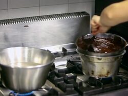 MS TD Shot of pastry chef mixing chocolate glaze on cooker with reflection in mirror / Rome, Lazio, Italy Stock Footage