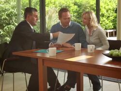 Wide, Track shot off couple signing contract at dinning table and handshake sales person Stock Footage