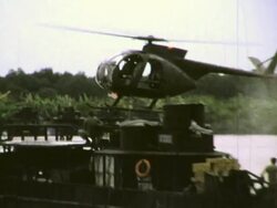 Helicopter landing on ARVN River Patrol Boat during Vietnam War Stock Footage