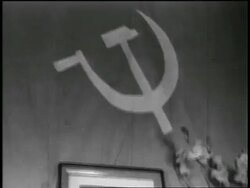B/W 1950s tilt down from Soviet flag to framed photograph of Ho Chi Minh on wall / newsreel Stock Footage
