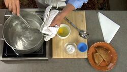 Overhead how to poach and egg in a pan of water on the stove. Stock Footage