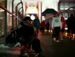 WS  Man sitting in wheelchair on city  walkway as people pass / Las Vegas,Nevada,USA Stock Footage