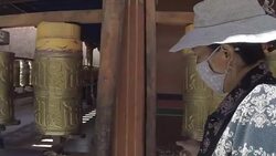 Woman spinning prayer wheels in Lhasa, Tibet Stock Footage