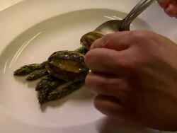Close up of chef serving cooked abalone on plate. Stock Footage