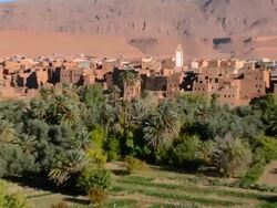 Village with beautiful mountains and green palm trees in Atlas Mountains in Morocco Stock Footage