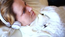 girl holding a tablet pc lying on a bed Stock Footage