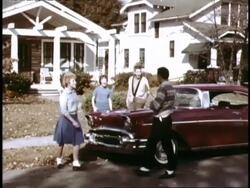 Teens gather around new 1957 Chevy Bel Air Stock Footage
