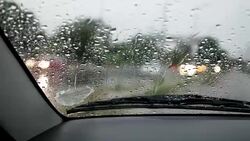Car moving forward during rainy season Stock Footage