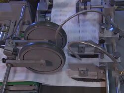 Medium static - Printed pages move through rollers and brushes in a factory /  Wisconsin, United States Stock Footage
