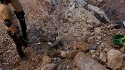 Digger clearing rubble in the aftermath of an airstrike News Clip