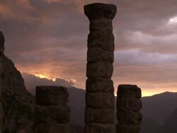 Medium static - Stone columns tower over the Delphi archeological site at sunset. / Delphi, Greece Stock Footage