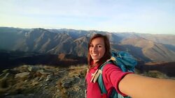 Young hiker taking selfie at mountain top Stock Footage