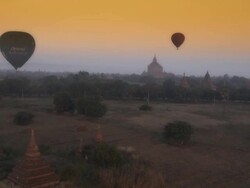 Aerial shot of pagodas and hot air balloons in Myanmar Stock Footage