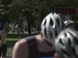 MS triathletes running by timer with bicycles / Chicago, Illinois, USA Stock Footage