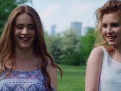 Friends walking in city park Stock Footage