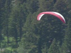 MS AERIAL ZO TS Shot of Paraglider flying over town / Wyoming, United States Stock Footage