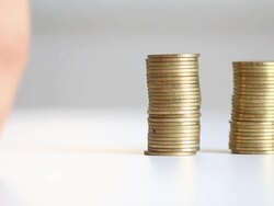 Hands putting coin into piggy bank Stock Footage