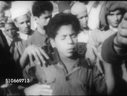 1953: TROUBLED MOROCCO: Policeman w/ nightstick chasing male, small group of males sitting in street, MS Policeman turning face of young teenager, arms up, forward. HA WS United Nations session, USSR Arkadiy Sobolev, two unidentified representatives. Instructional Video