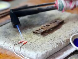 Goldsmith Jeweler use gasoline burner melting and decorating Jewel Stock Footage