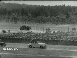 1942: FORT JACKSON REVIEW: Angled WS US Army Jeeps parked in formation on field, WS Convertible car (Brigadier General William C. Lee & British Prime Minister Winston Churchill on back) driving past soldiers gathered for inspection.  WWII, training, Instructional Video